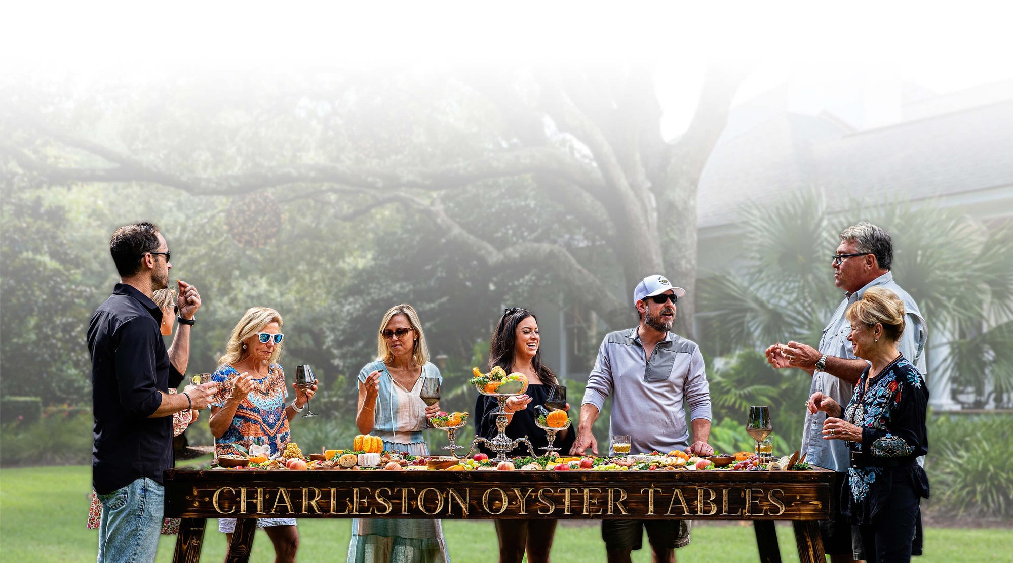 people gathered around a Charleston Oyster Table